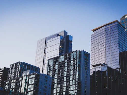 Commercial office towers against an evening sky