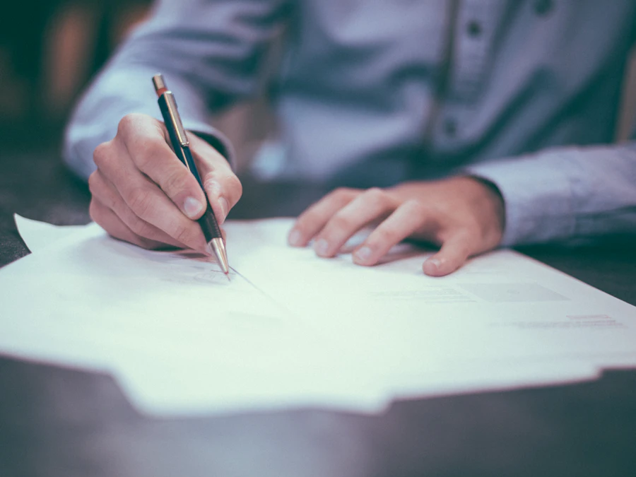 Hand signing a property document